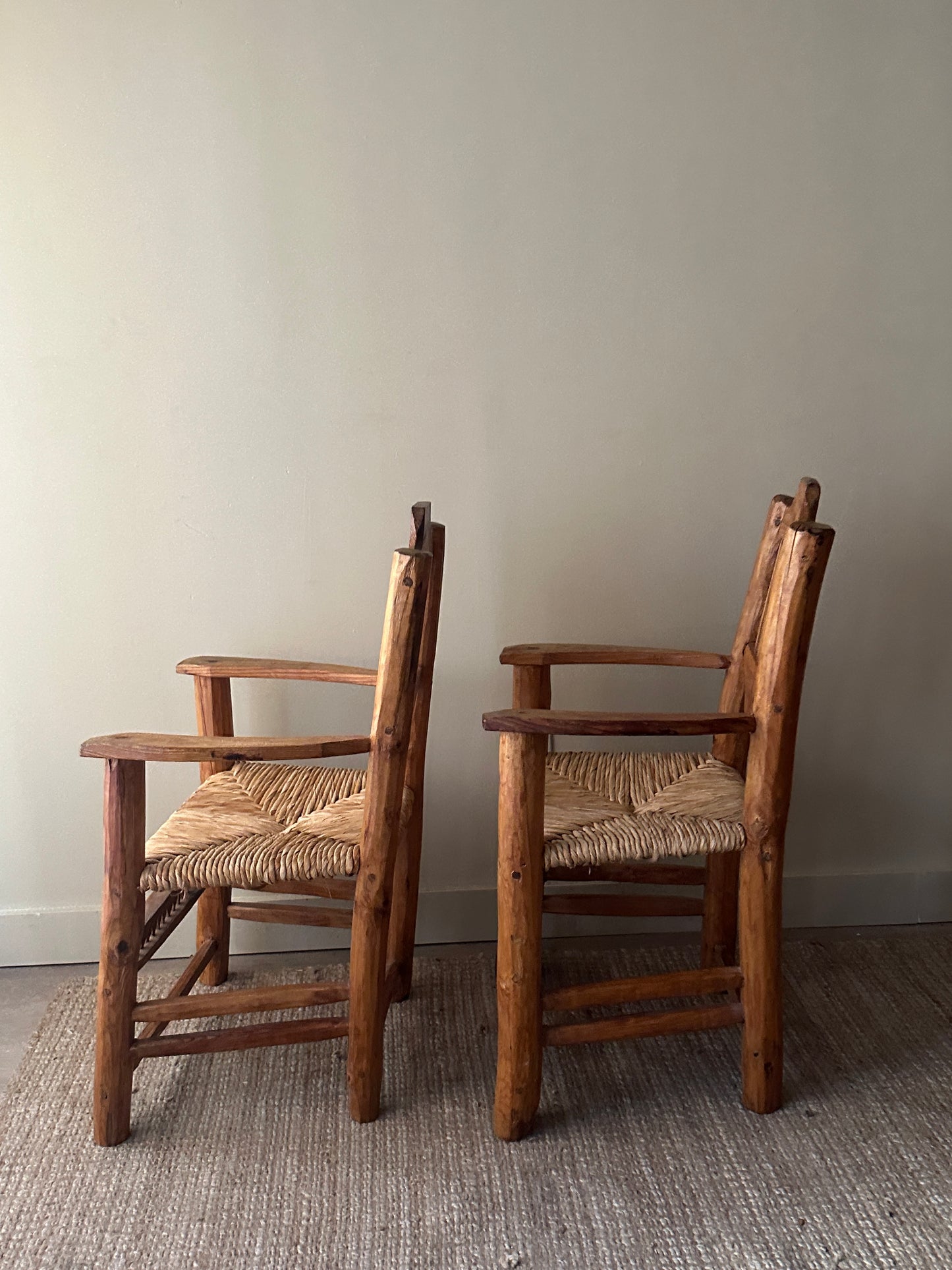 Pine rush seat dining chairs with arms. Sold individually.
