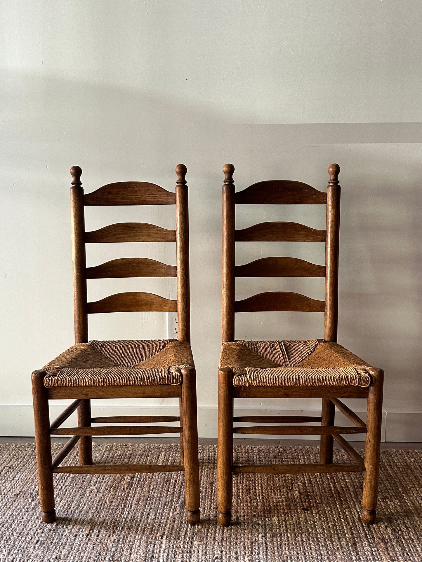 Pair of farmhouse ladder back chairs. Sold as a pair.