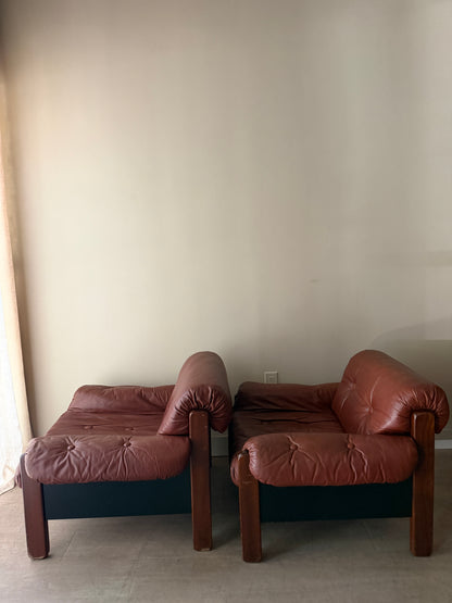 Swedish Brutalist brown leather lounge chairs. Sold individually.