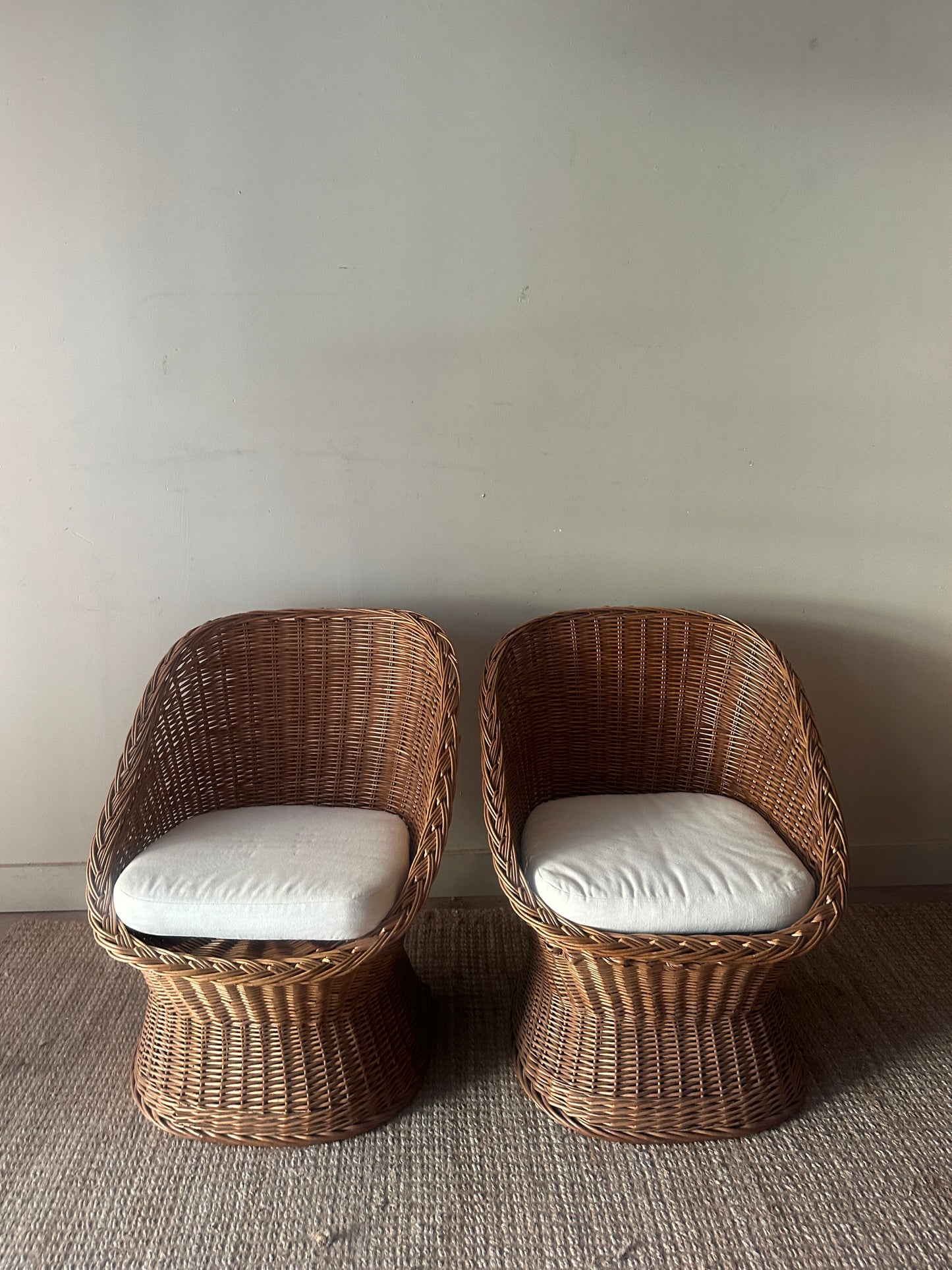 Wicker lounge chairs. Sold individually.