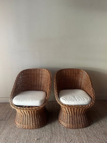 Wicker lounge chairs. Sold individually.