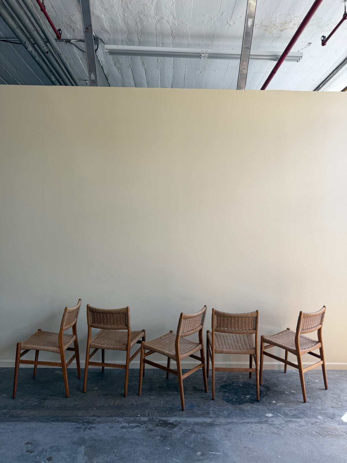 Danish oak and papercord chairs. Sold individually.