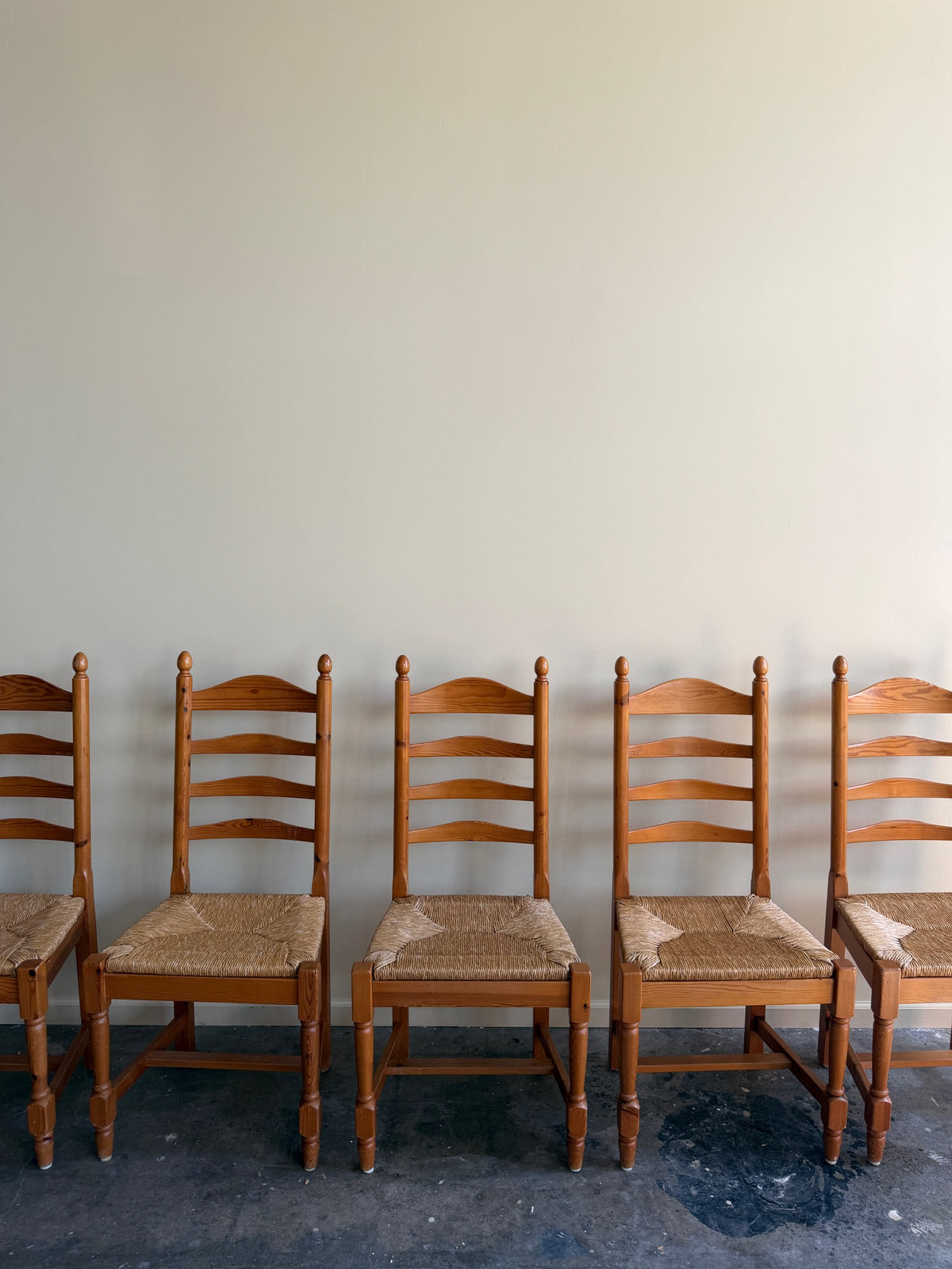 Dutch pine rush seat ladderback dining chairs. Sold individually.