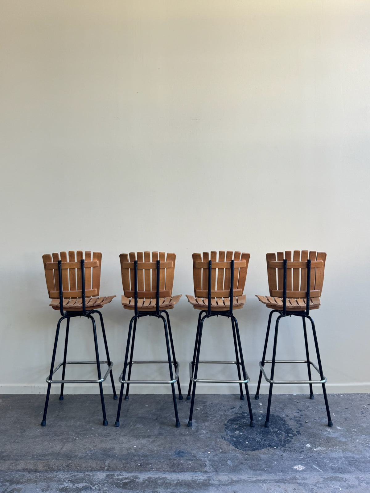 Slatted maple swivel bar stools. Sold in pairs.