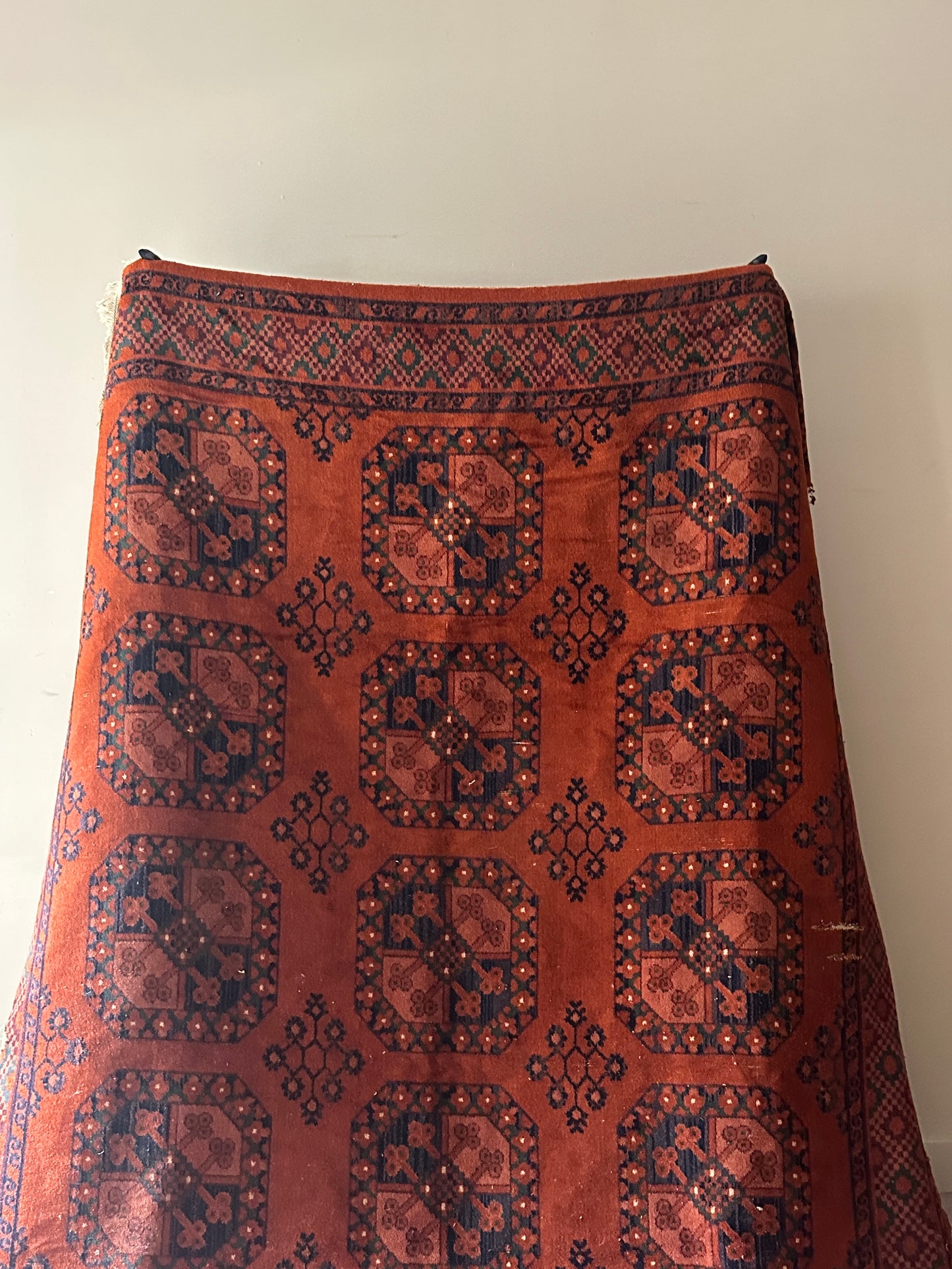 Low pile, rust colored rug