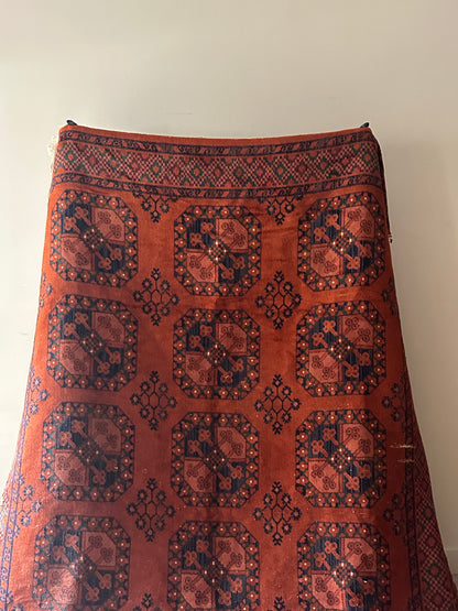Low pile, rust colored rug