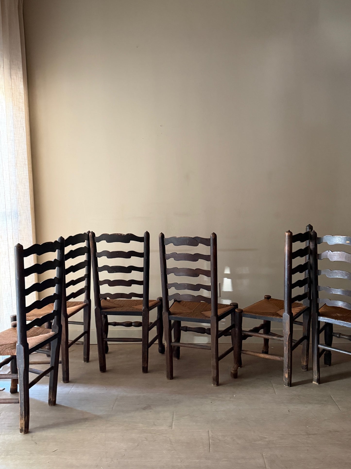English provincial elmwood ladder back rush seat chairs. Sold in pairs.