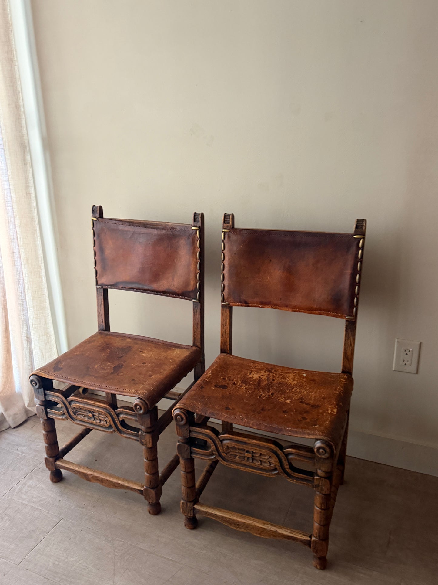 Spanish leather and oak chairs. Sold individually.