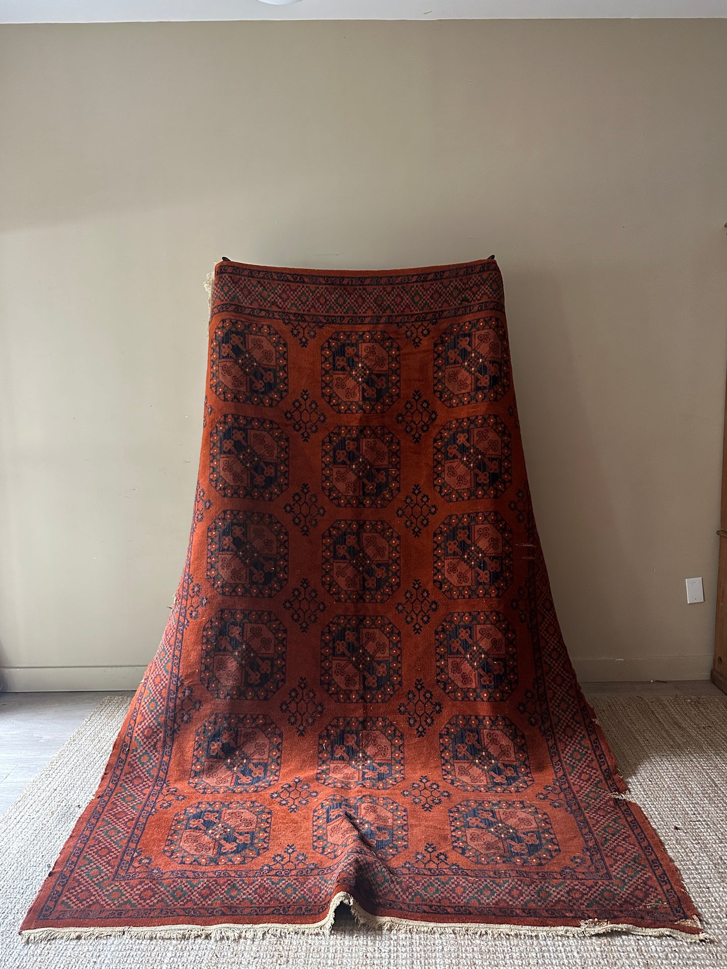 Low pile, rust colored rug