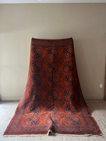 Low pile, rust colored rug