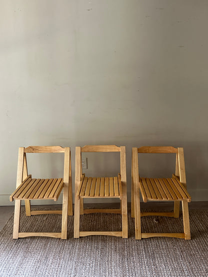 Oak folding chairs. Sold individually.