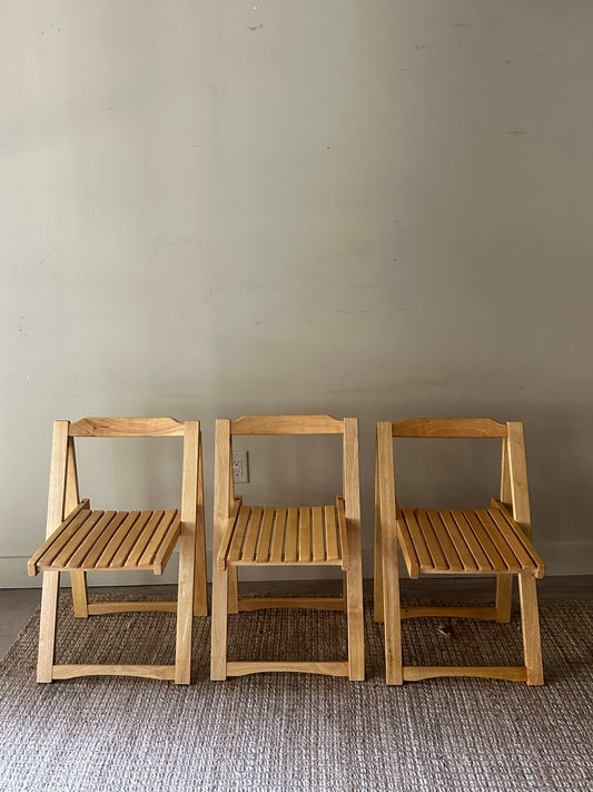 Oak folding chairs. Sold individually.