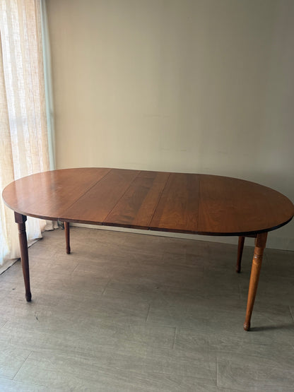Round walnut dining table with extensions
