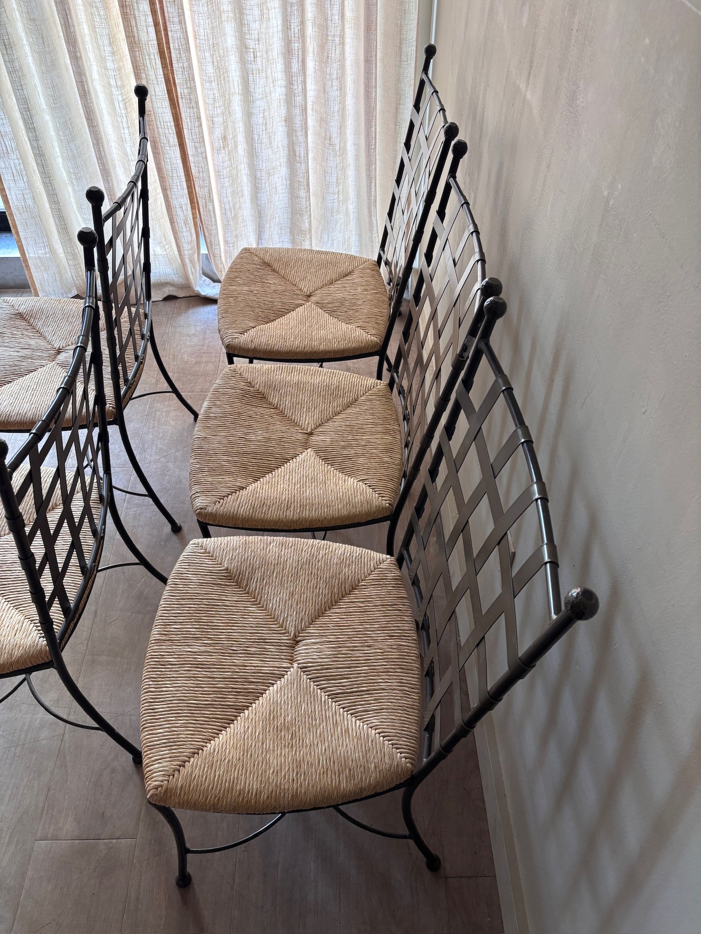 Wrought iron rush seat dining chairs. Sold individually.