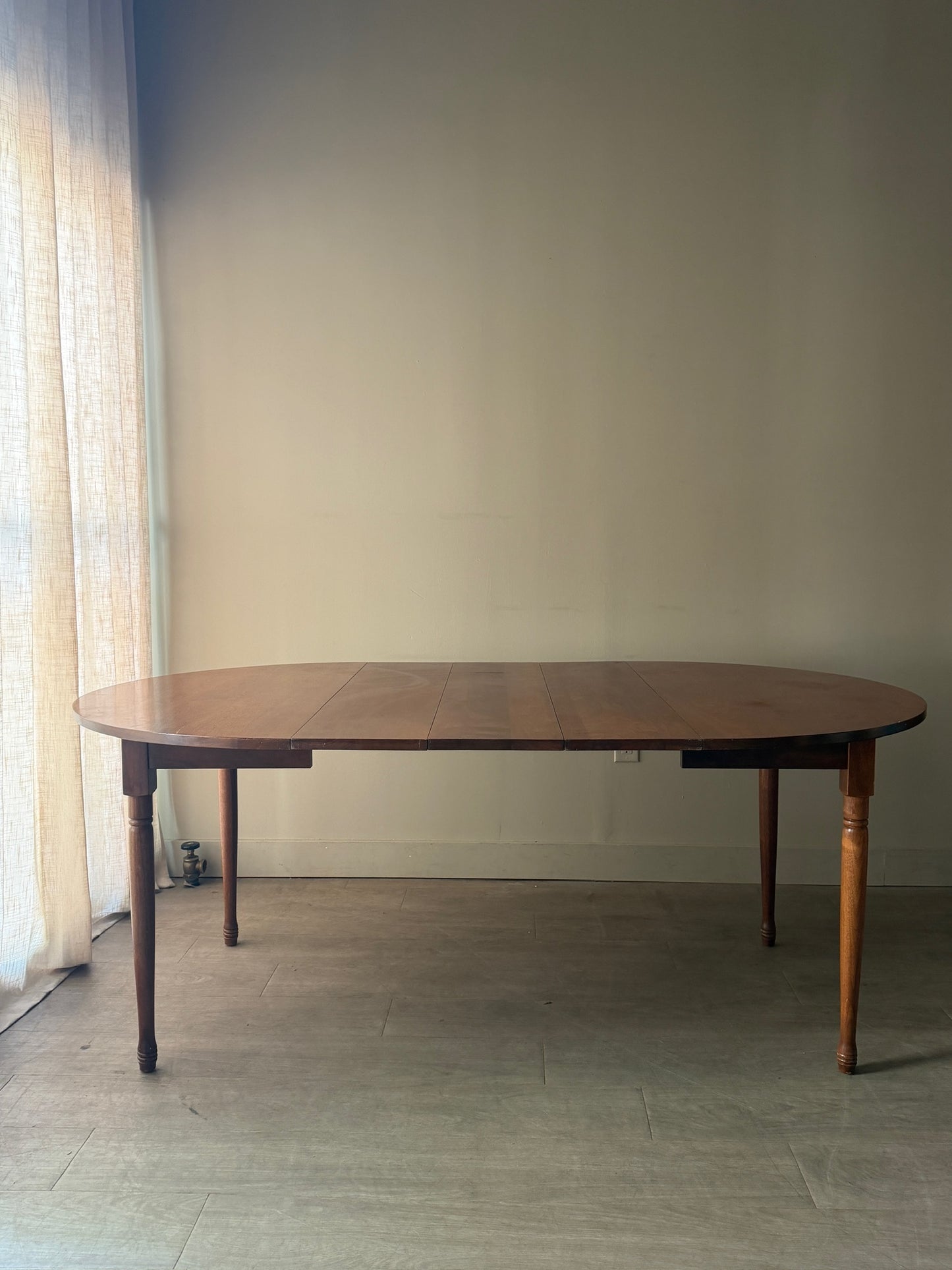 Round walnut dining table with extensions