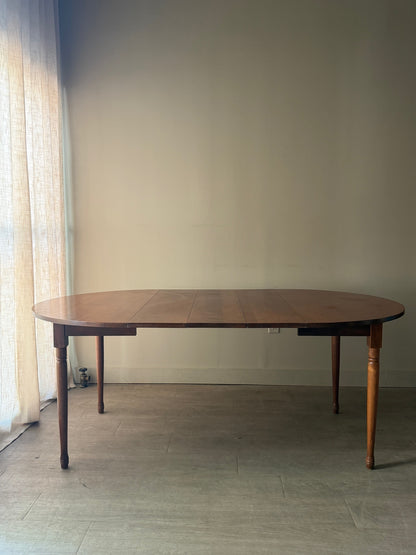 Round walnut dining table with extensions