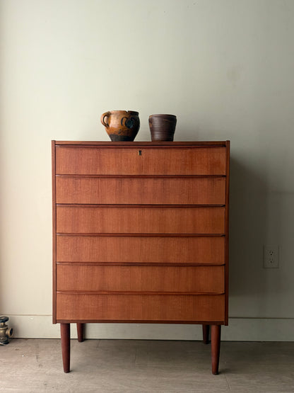 Danish teak tallboy dresser (left)