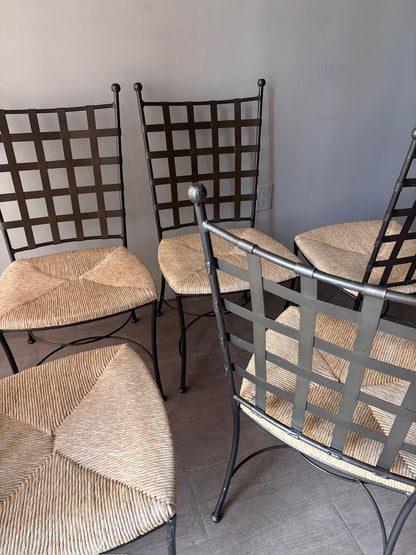 Wrought iron rush seat dining chairs. Sold individually.