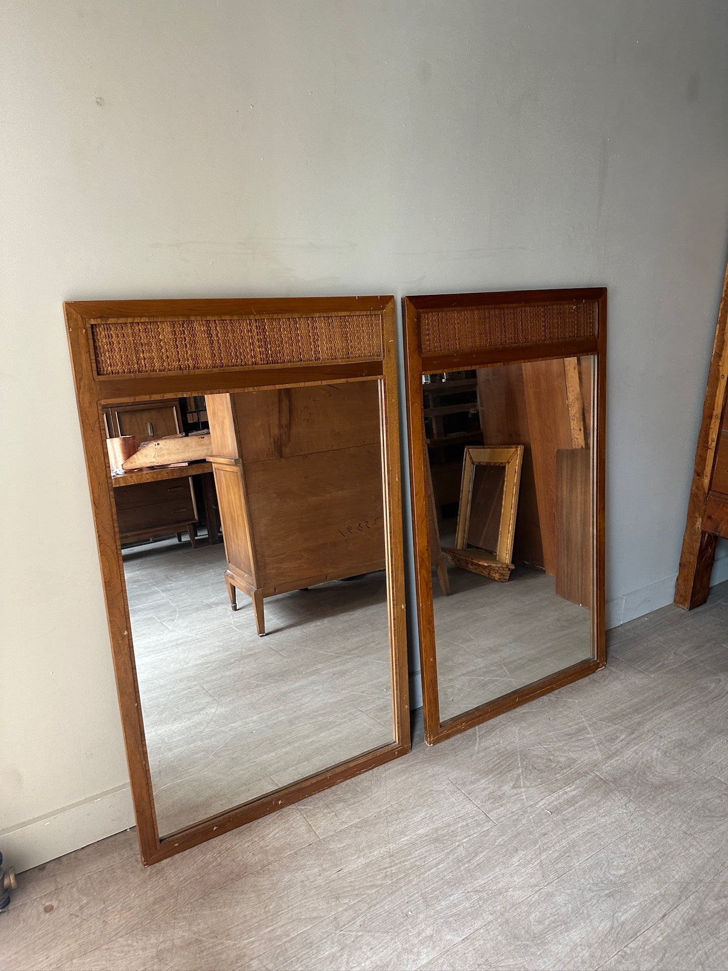 2 walnut and cane mirrors. Sold individually.