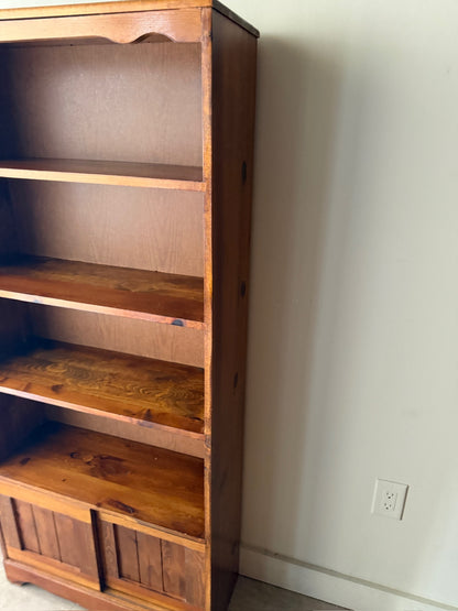 Pine bookcase with sliding doors