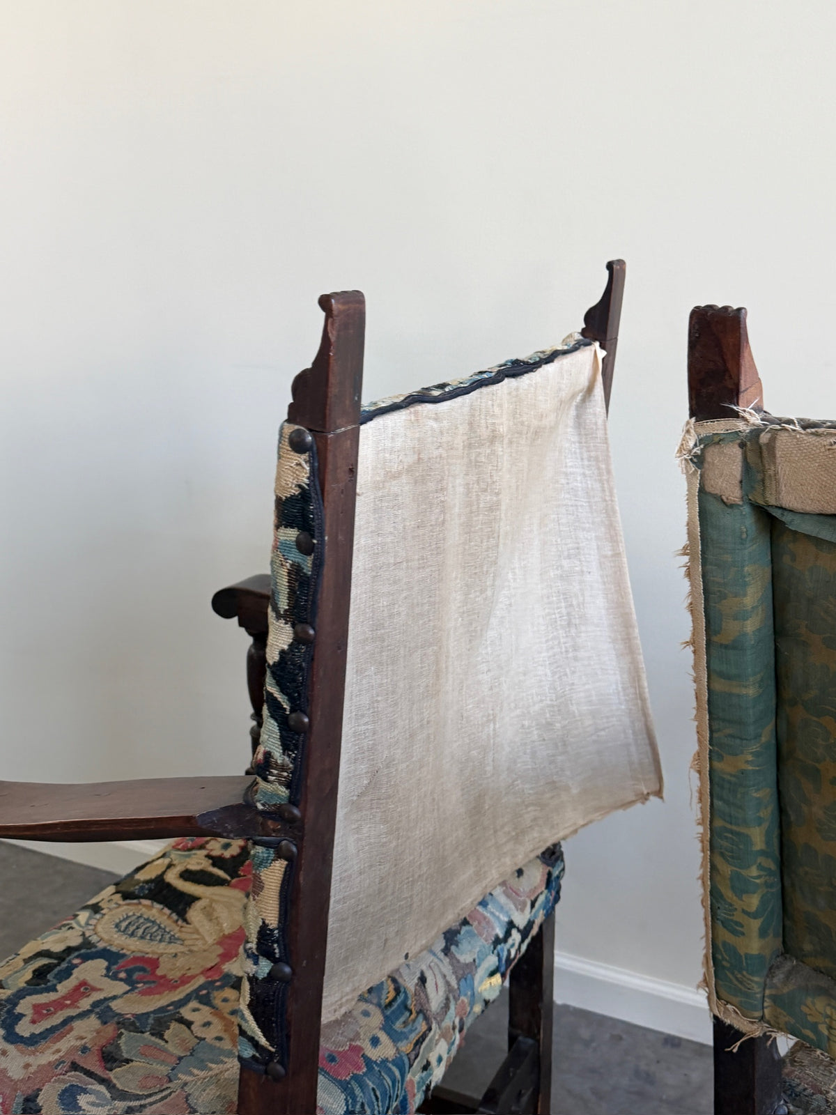 Italian Baroque upholstered walnut armchairs (left)