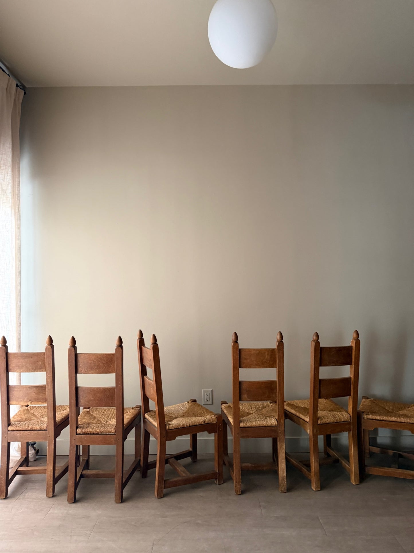 Dutch Brutalist oak rush seat dining chairs. Sold in pairs.
