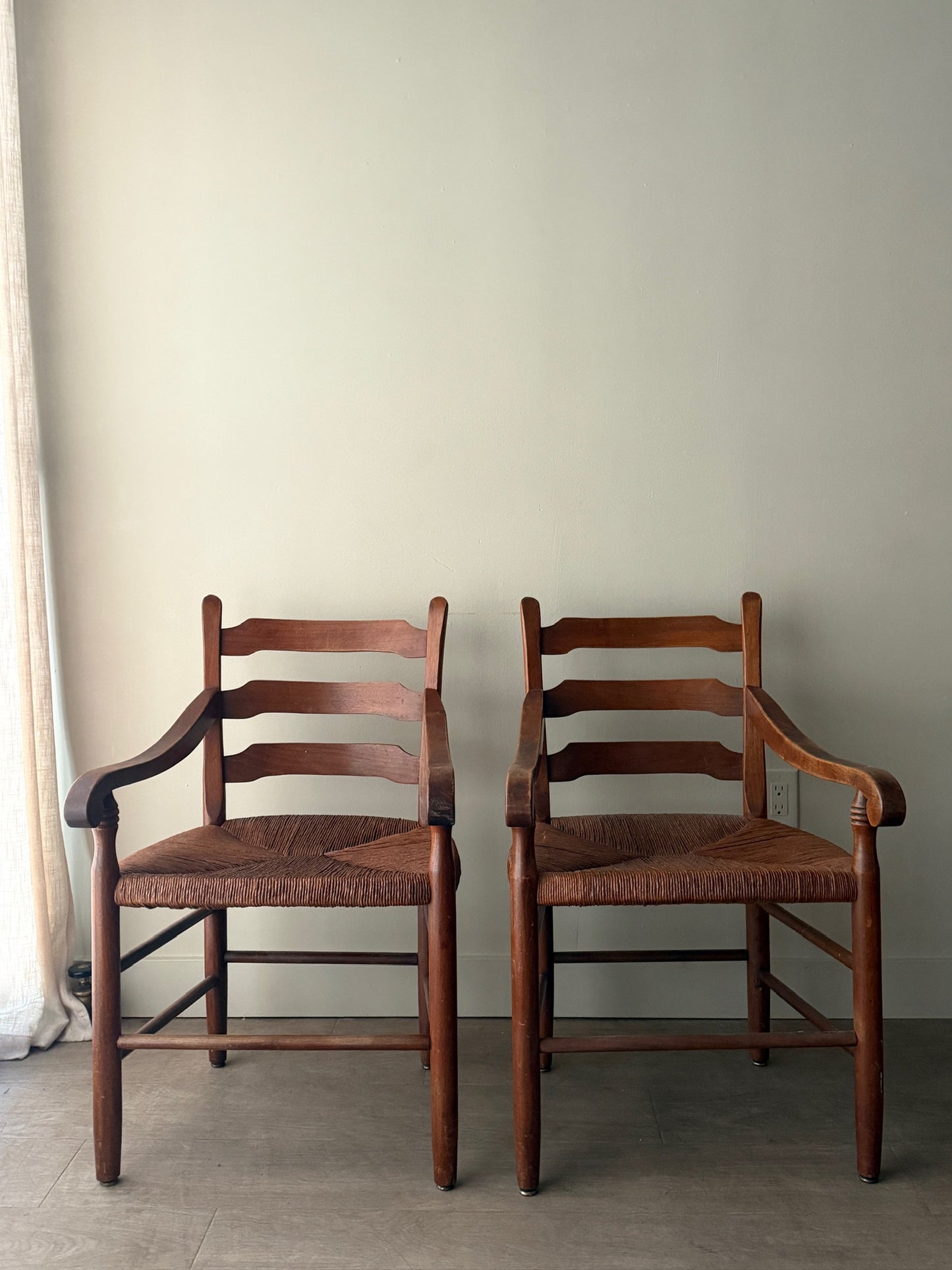 Ladder back rush seat pine arm chairs. Sold individually.