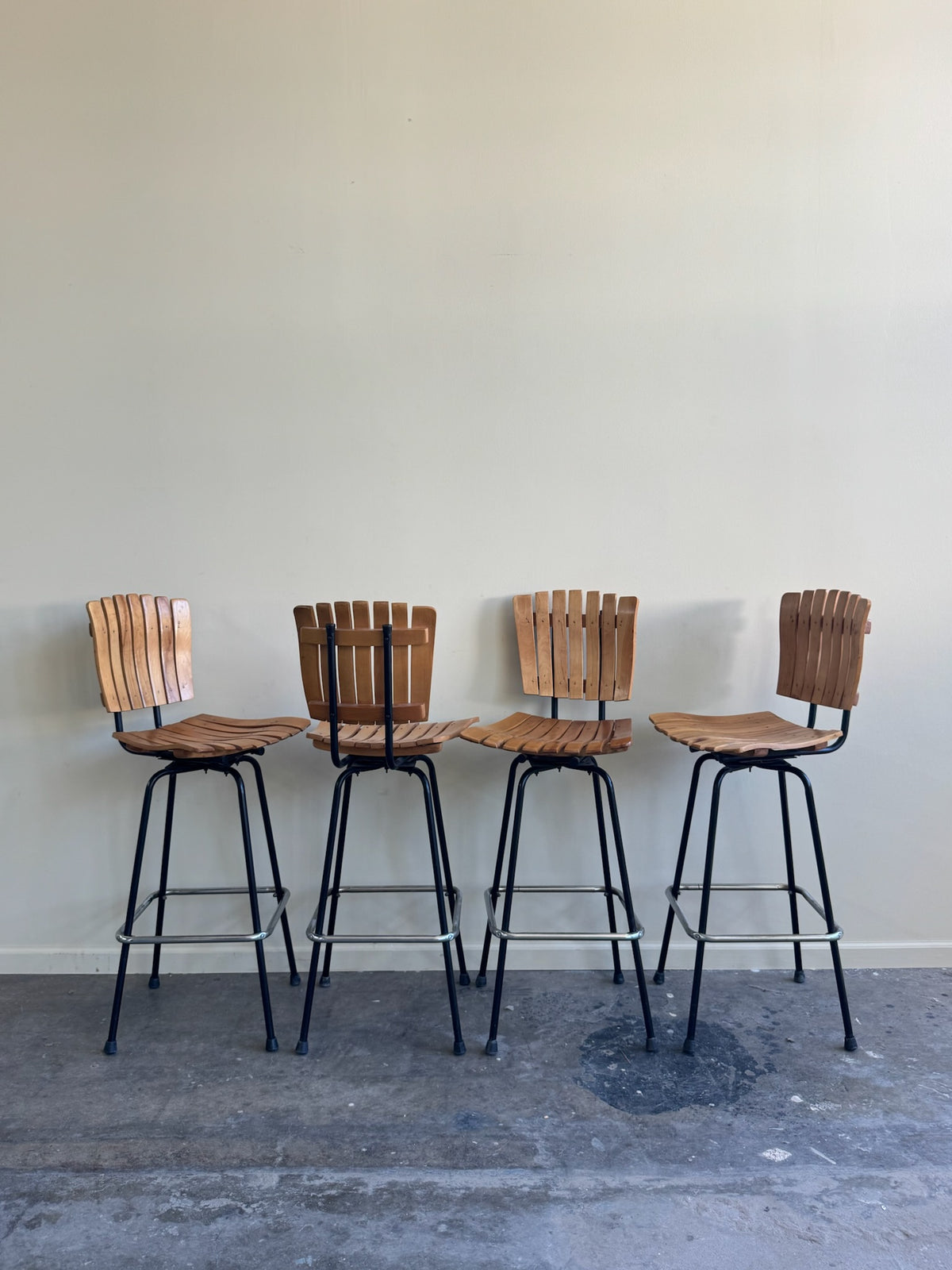 Slatted maple swivel bar stools. Sold in pairs.