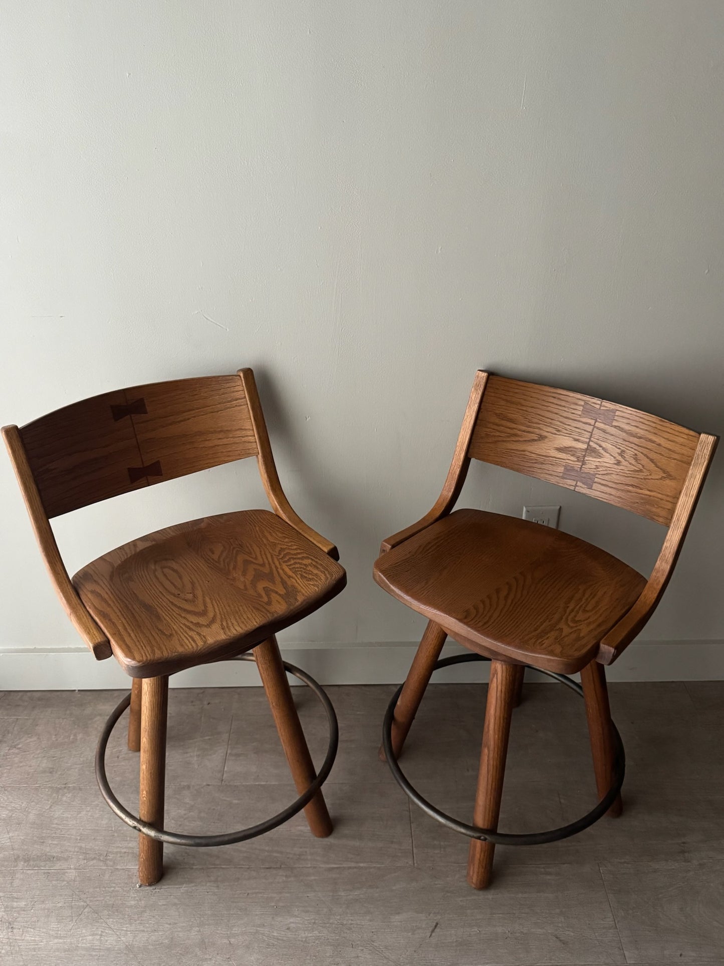 Conant Ball oak swivel bar stools. Sold as a pair.