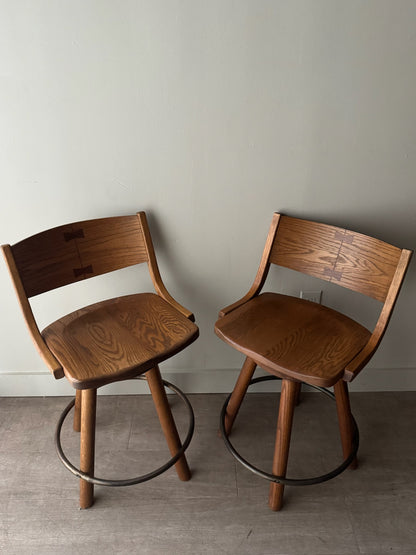 Conant Ball oak swivel bar stools. Sold as a pair.