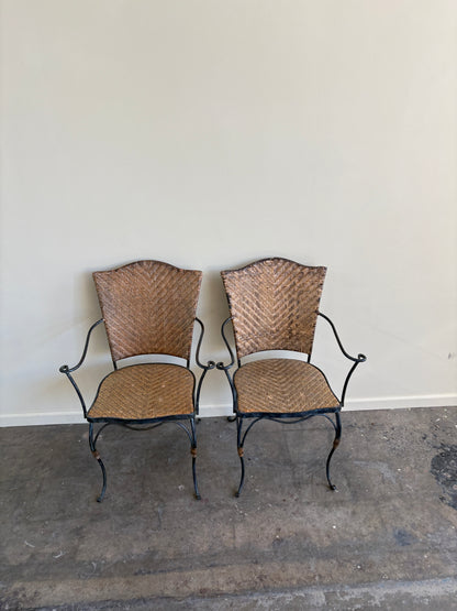 Wrought iron armchairs with woven bamboo backs & seats. Sold individually.
