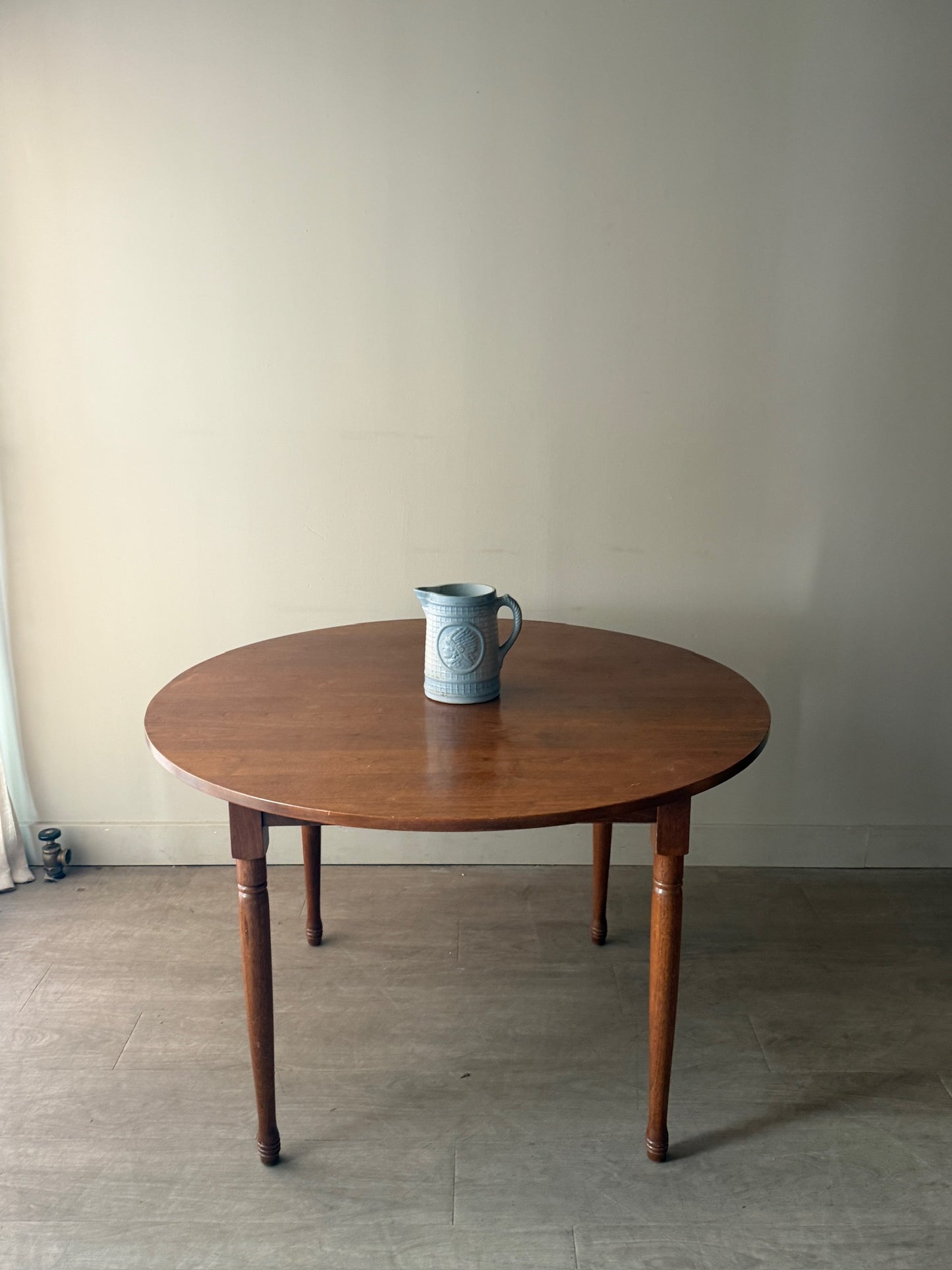 Round walnut dining table with extensions