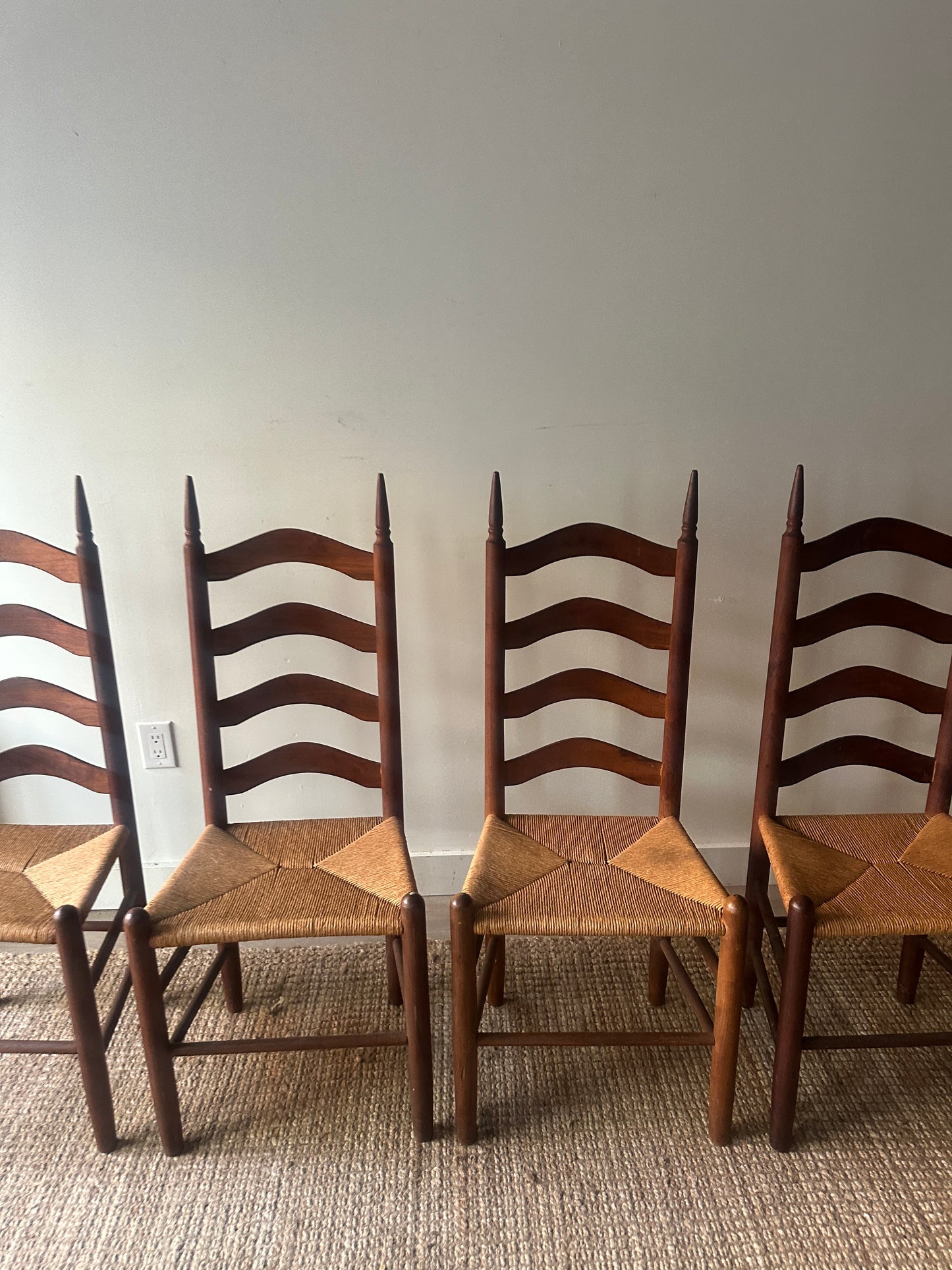 Ladder back rush seat chairs. Sold individually.