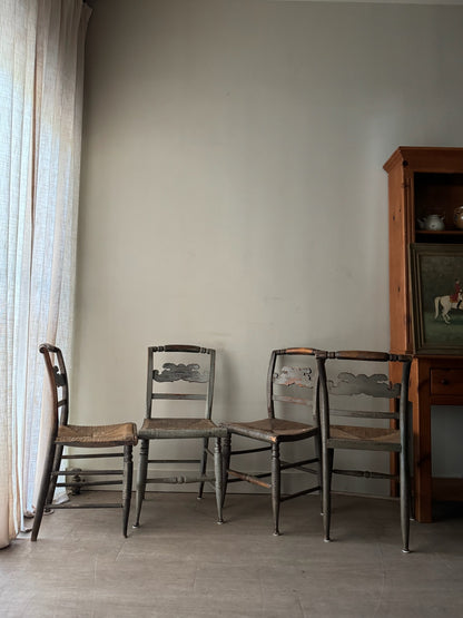 Carved dining chairs with rush seats. Sold in pairs.