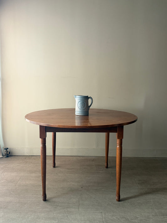 Round walnut dining table with extensions