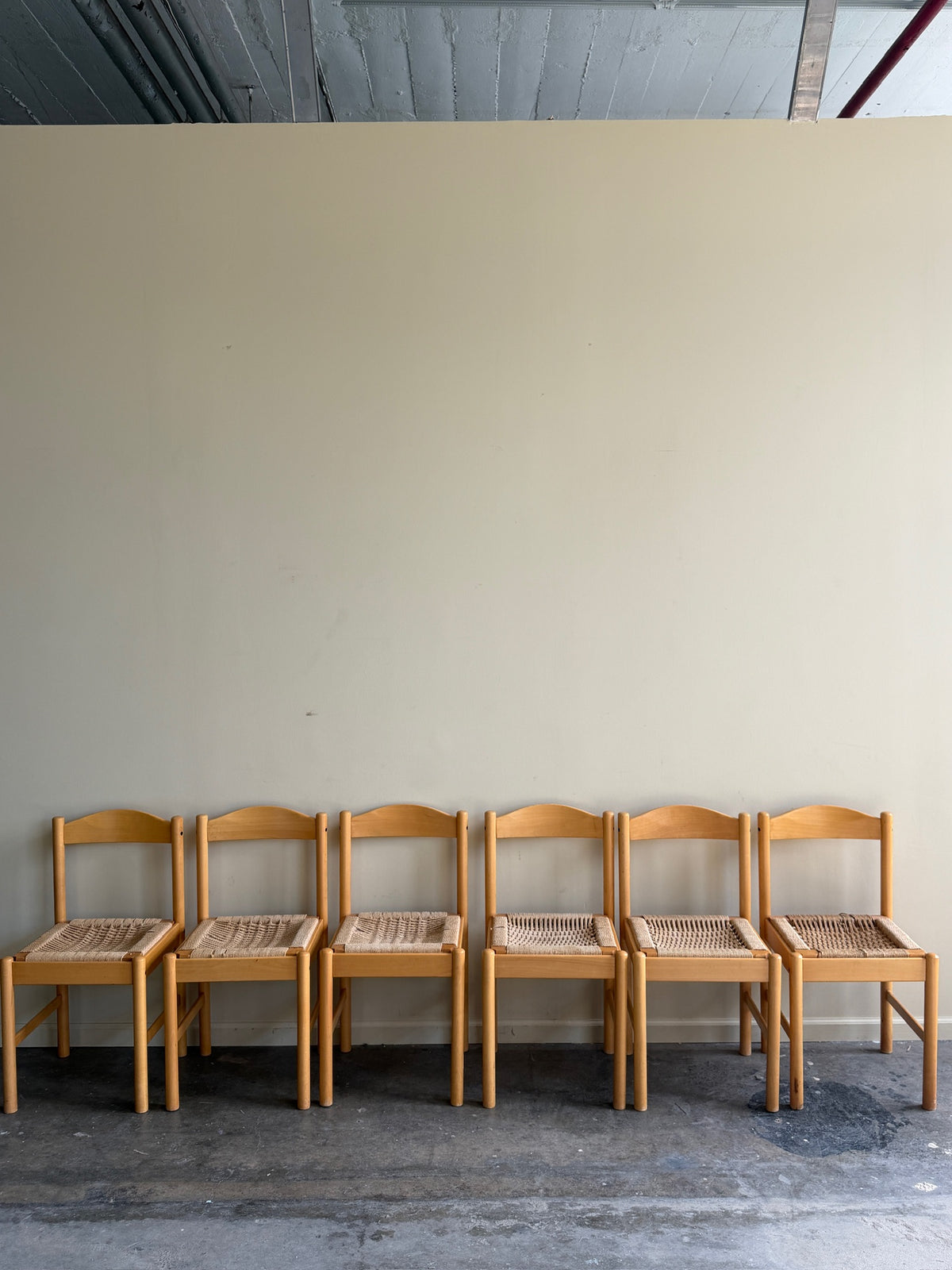 Maple dining chairs with twisted rope seats. Sold in pairs.