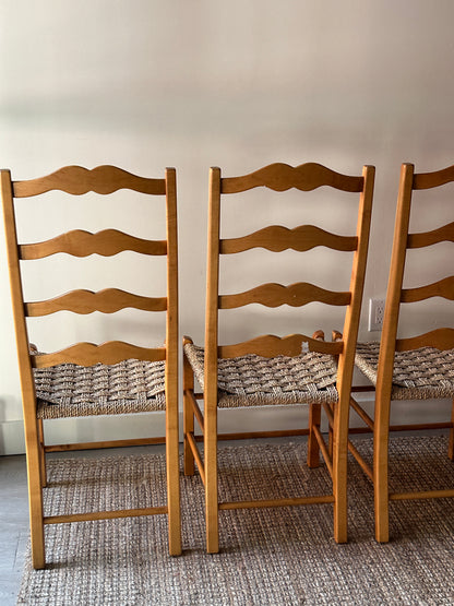 Ladder back chairs with woven seats. Sold in sets of 2.