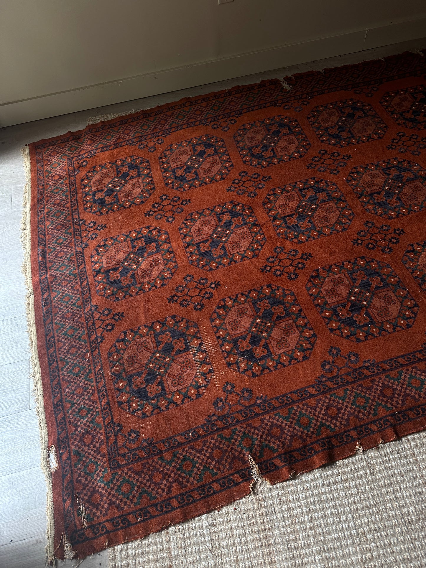 Low pile, rust colored rug