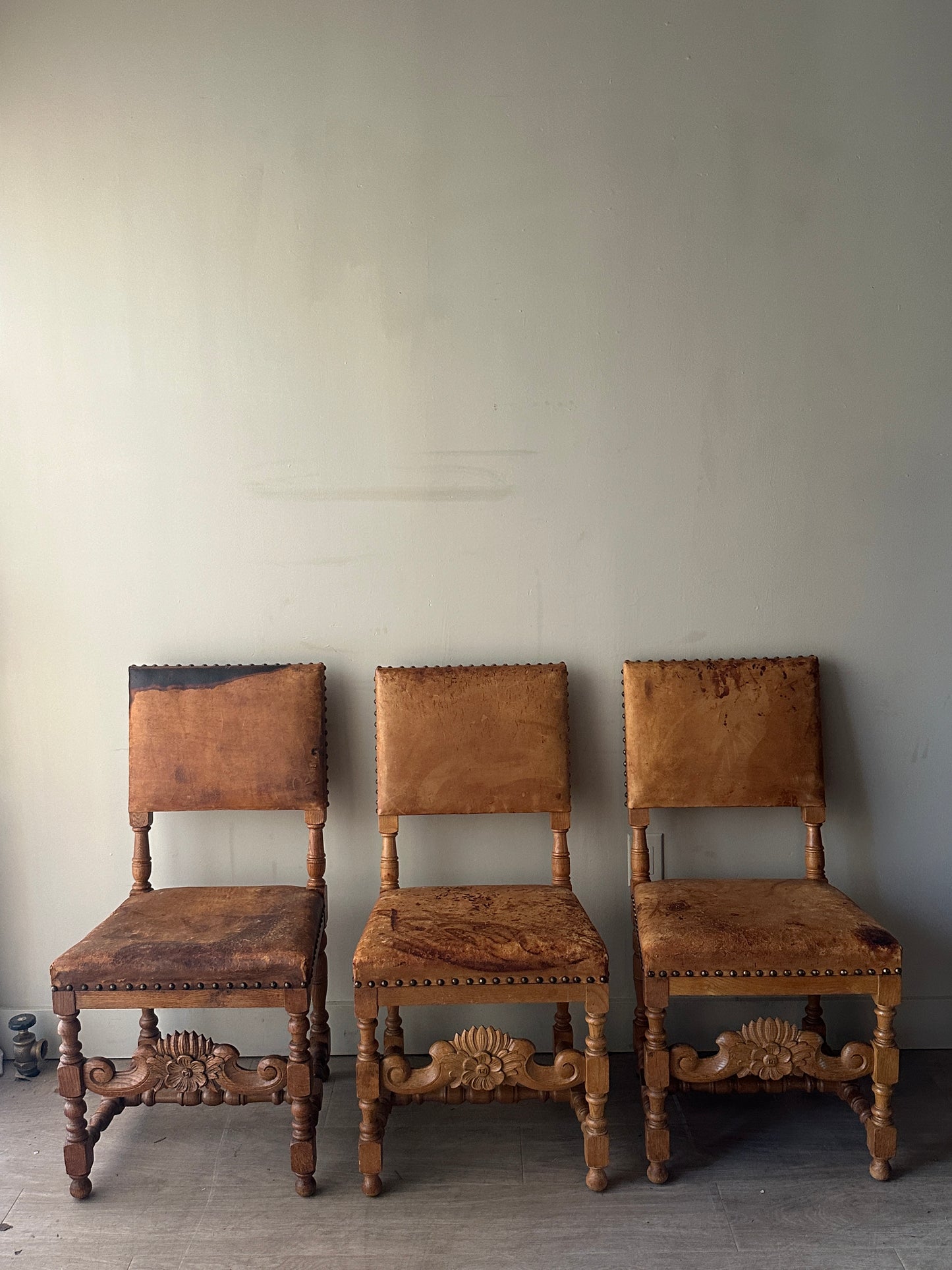 Leather and oak dining chairs. Sold individually.