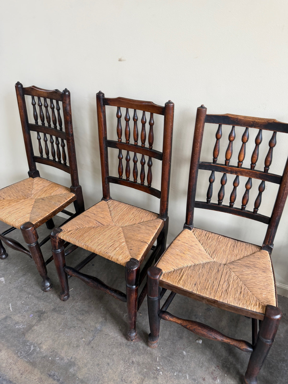Dutch oak spindle back rush seat dining chairs. Sold in pairs.