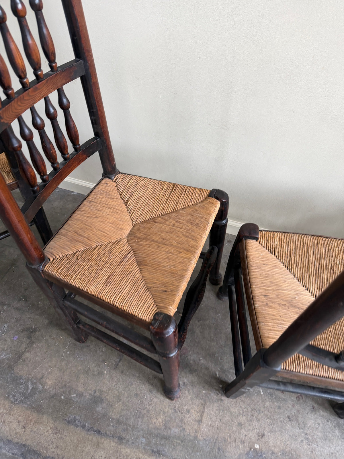 Dutch oak spindle back rush seat dining chairs. Sold in pairs.