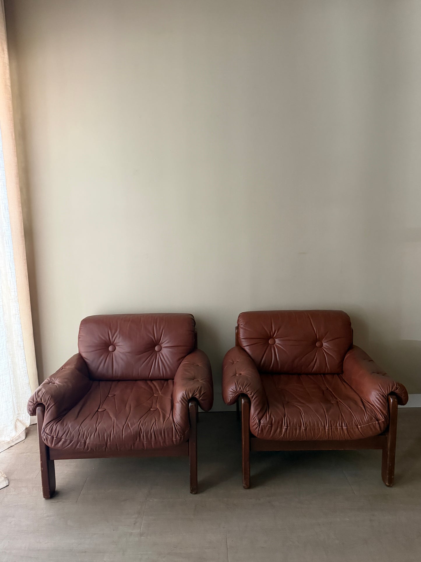 Swedish Brutalist brown leather lounge chairs. Sold individually.