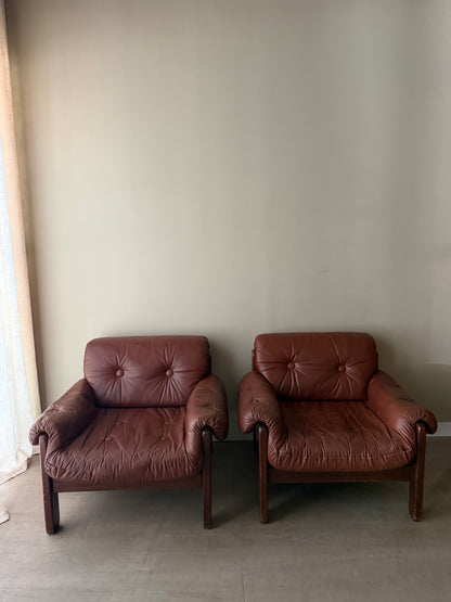 Swedish Brutalist brown leather lounge chairs. Sold individually.