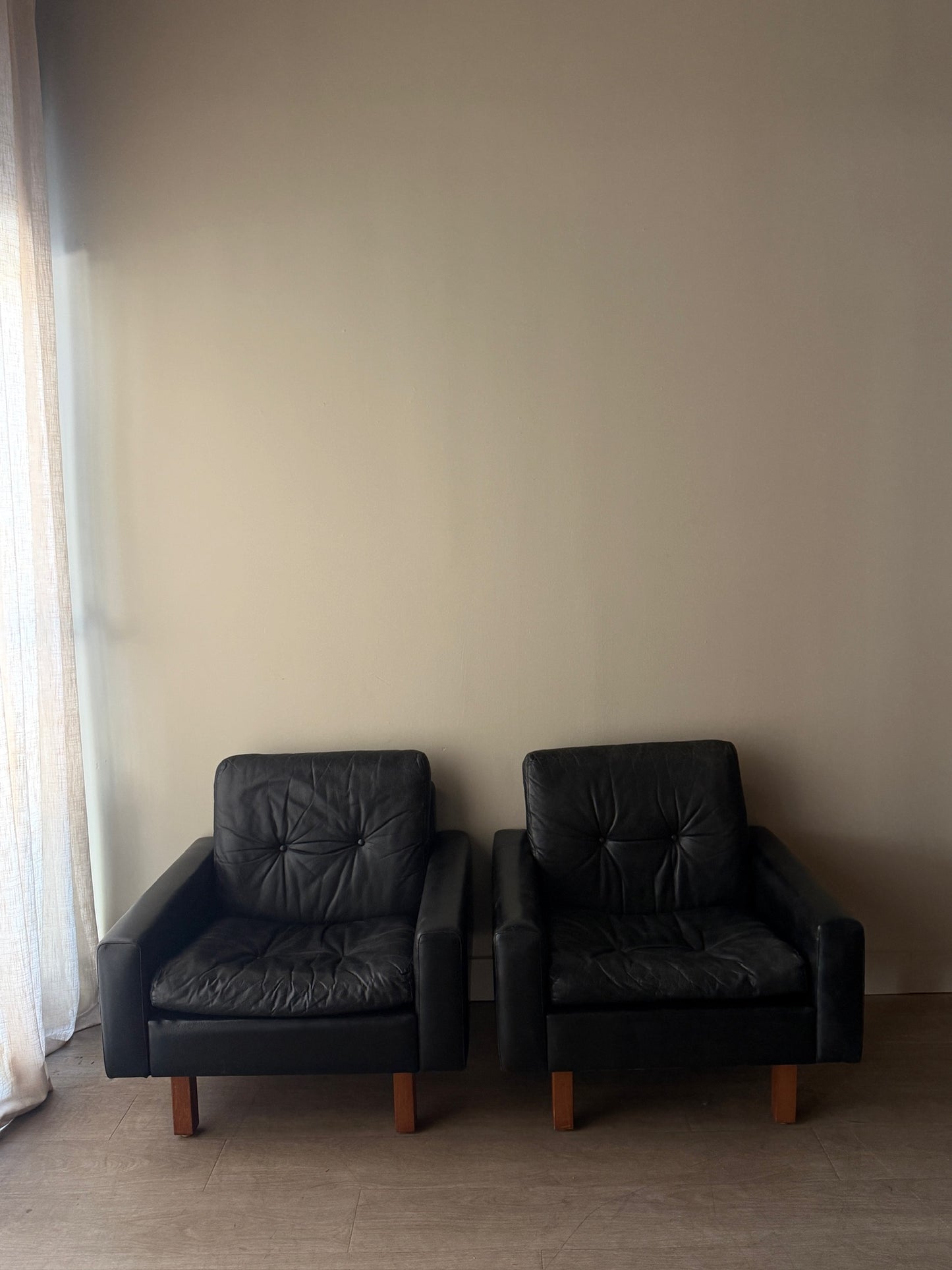 Danish black leather lounge chairs. Sold individually.
