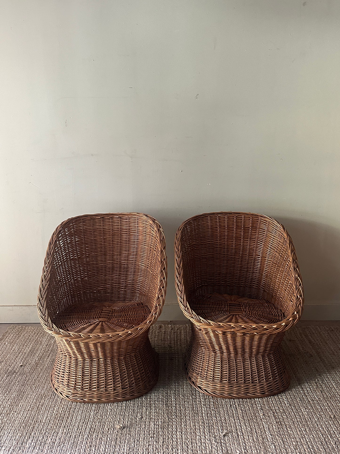 Wicker lounge chairs. Sold individually.