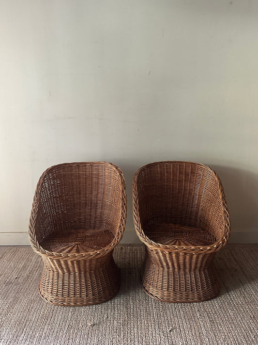 Wicker lounge chairs. Sold individually.