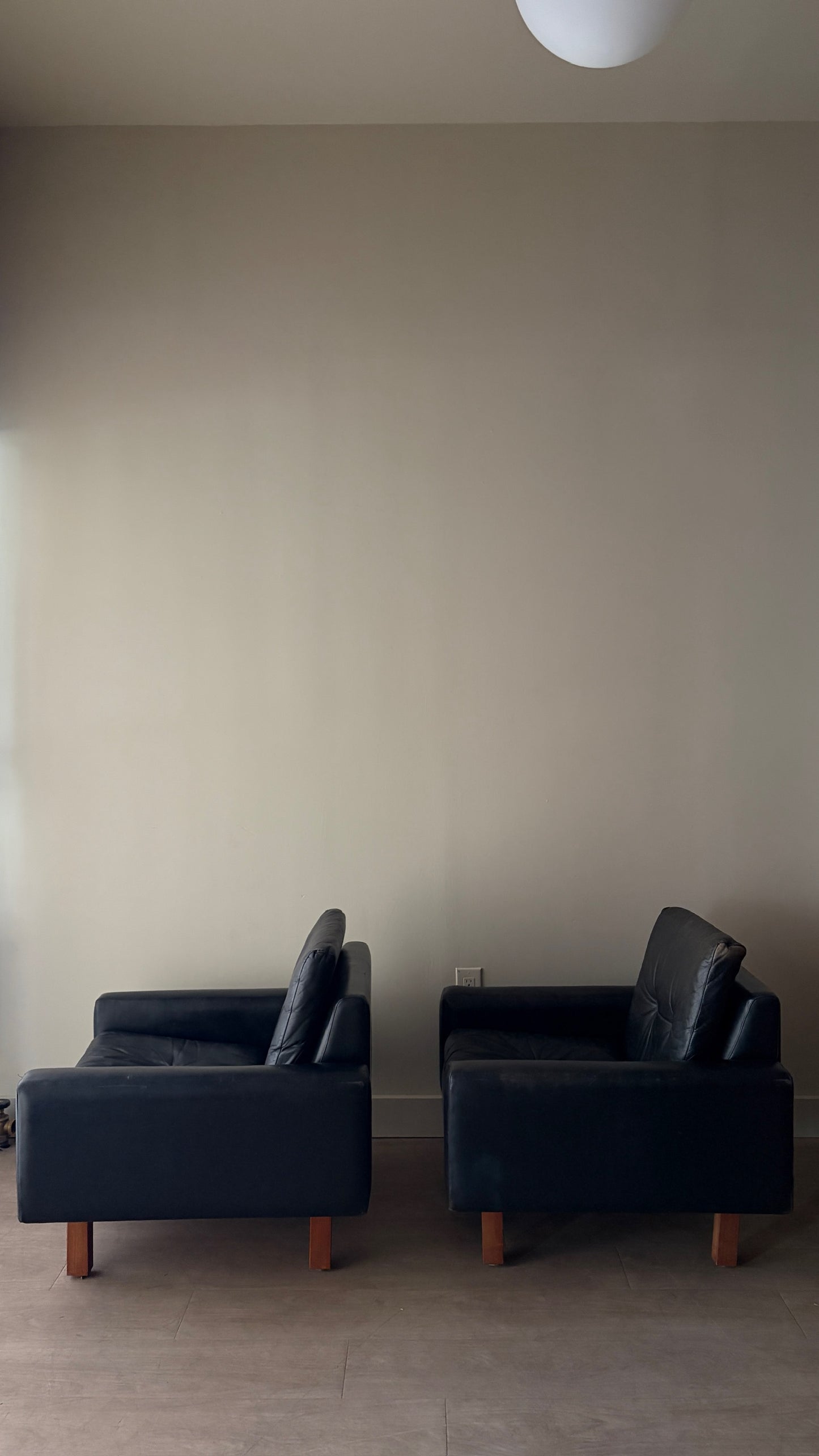 Danish black leather lounge chairs. Sold individually.