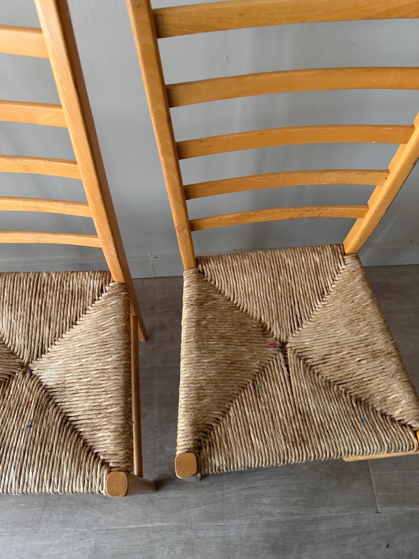 Maple ladder back dining chairs with rush seats. Sold in pairs.