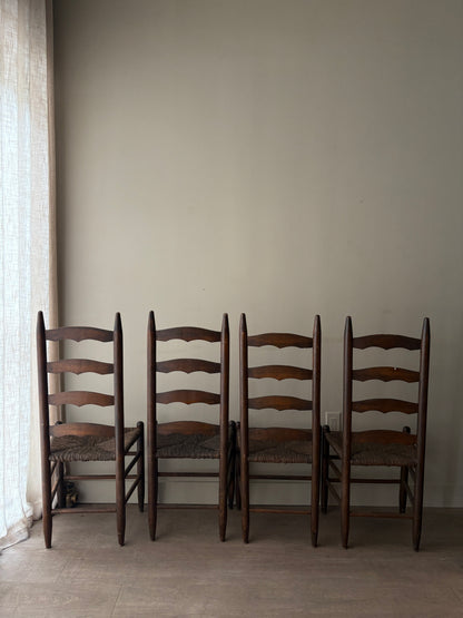 Stained oak rush seat ladder back dining chairs. Sold in pairs.