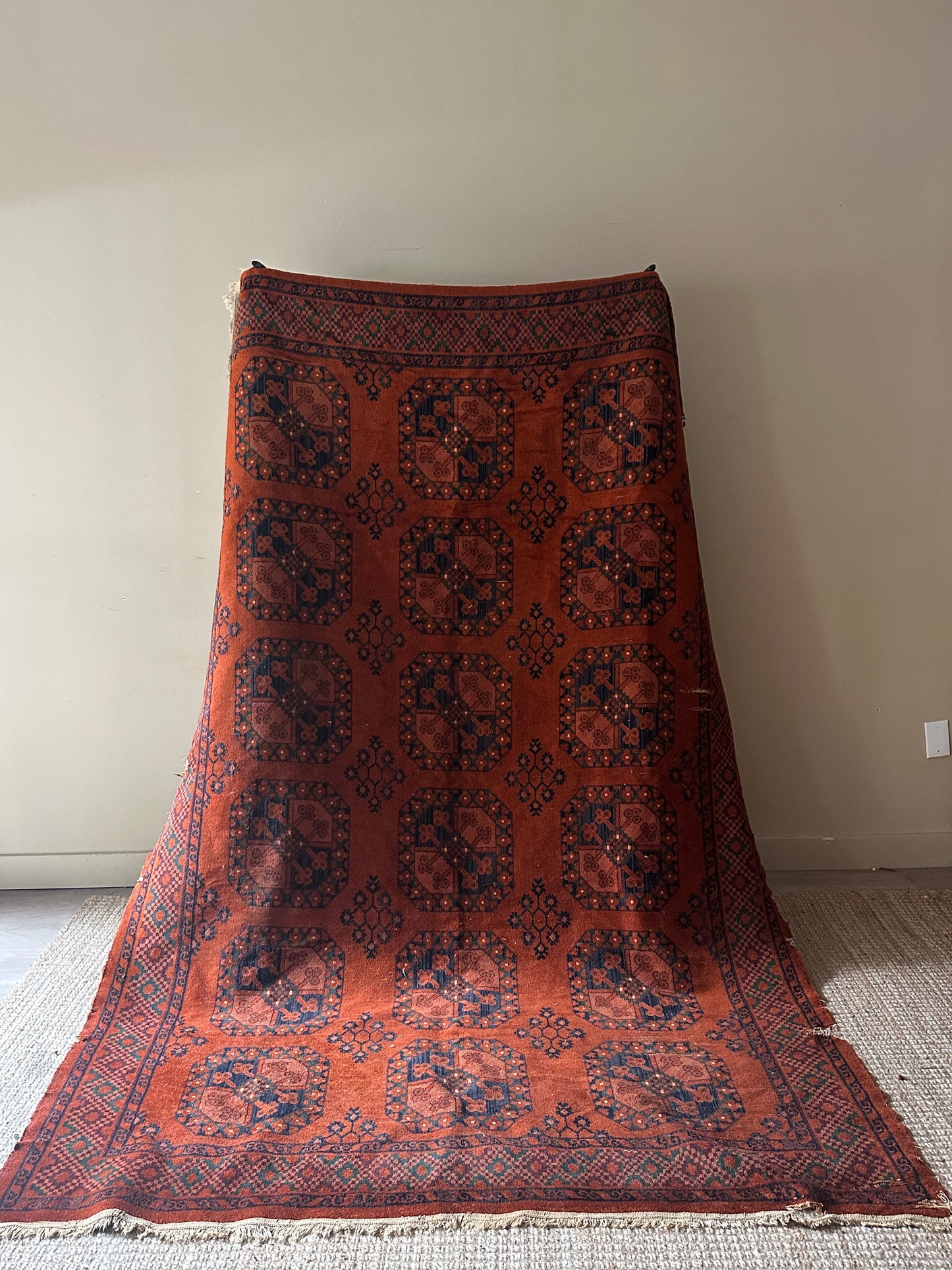 Low pile, rust colored rug